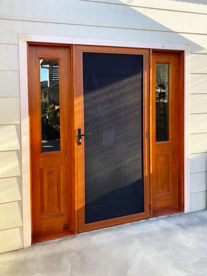 Hinged wooden door and ScreenGuard security screen door with sidelights on front entrance installed by Olsen Security