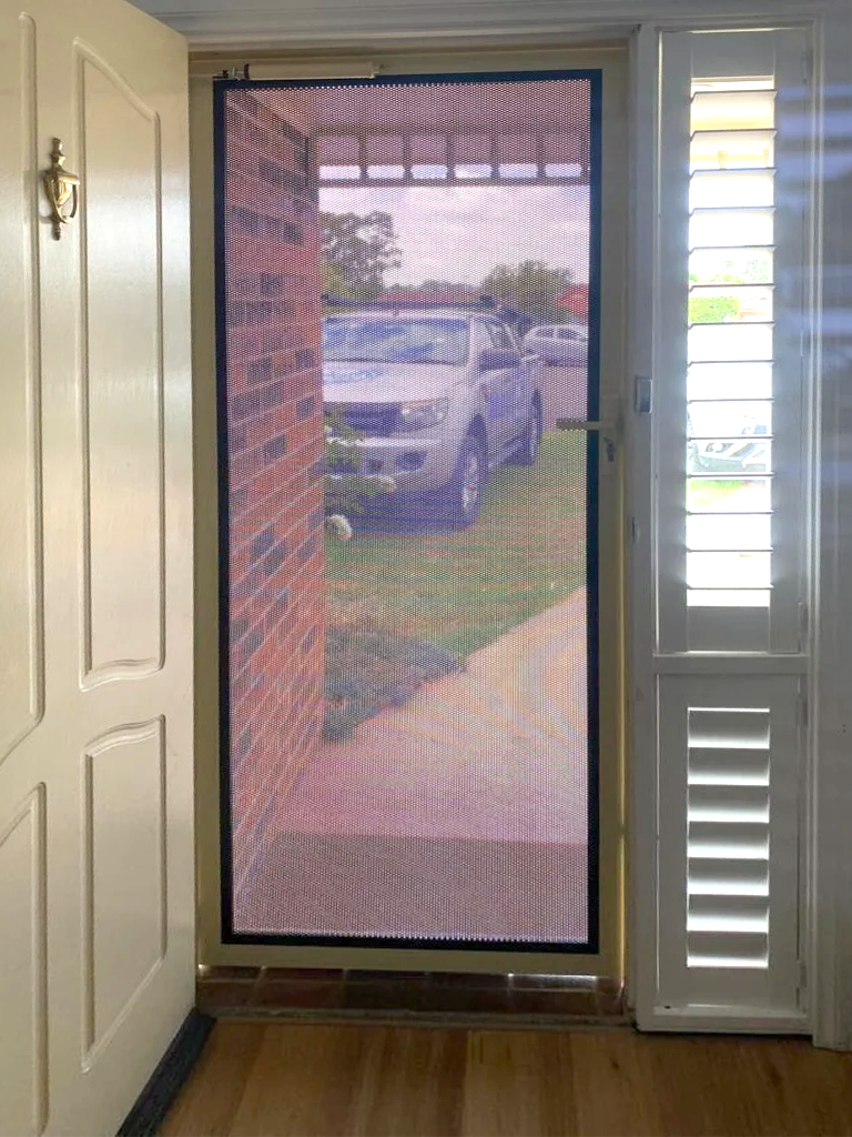 Security screen door on front entrance installed by Olsen Security