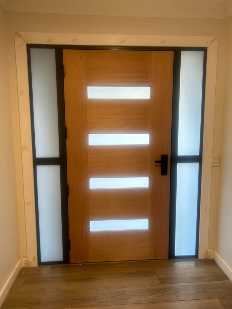 Timber entrance door with sidelights installed by Olsen Security