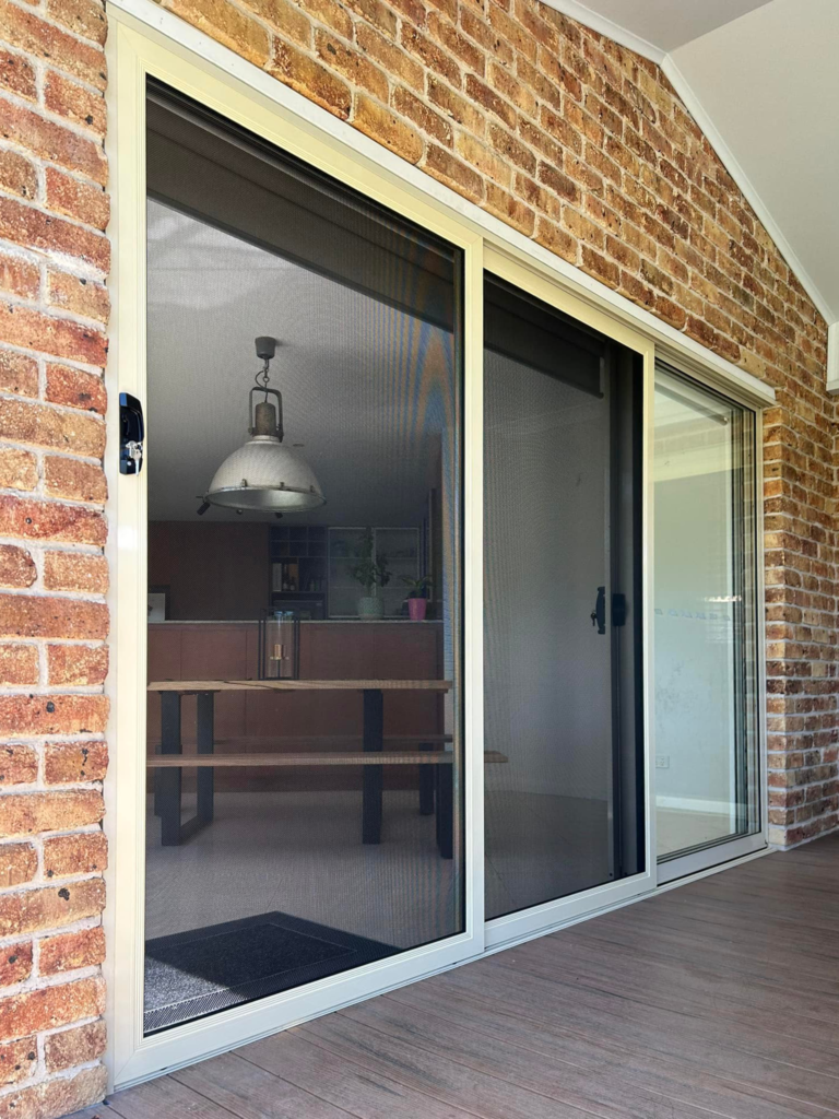 Security sliding doors opening to outdoor area installed by Olsen Security
