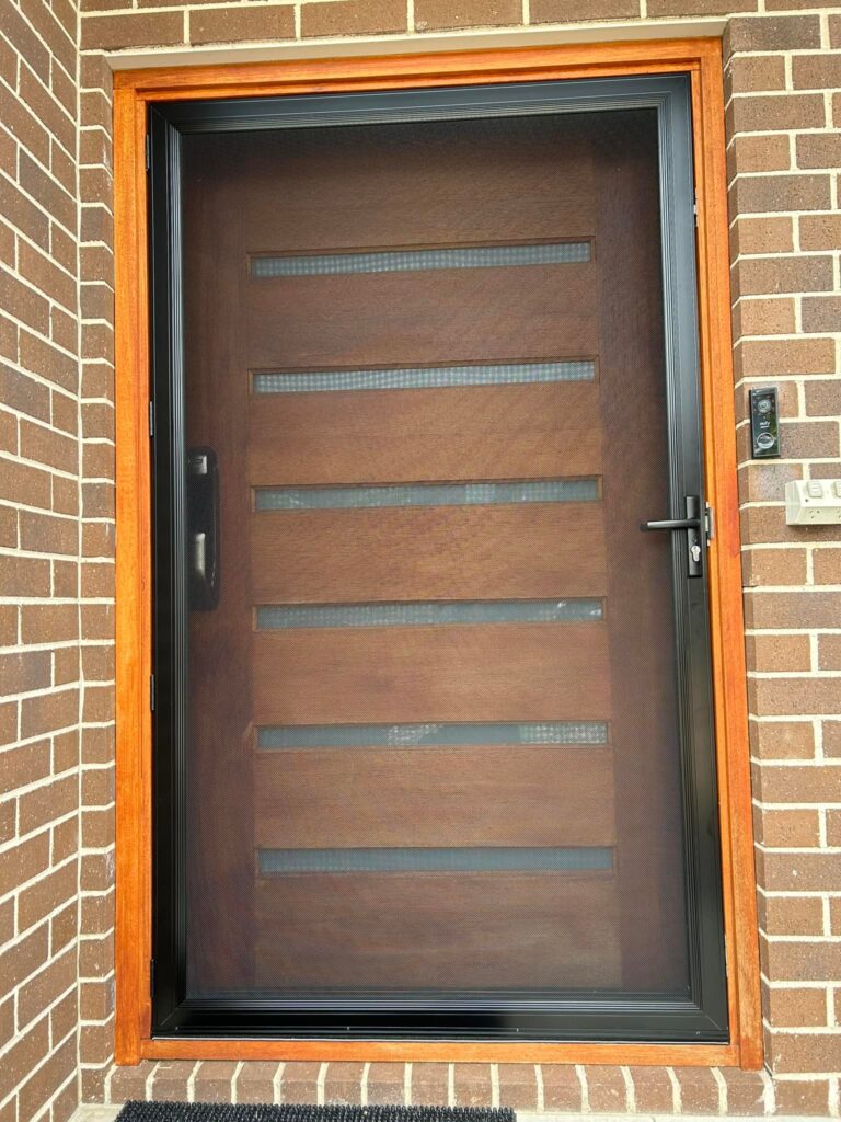 Security screen door on front entrance installed by Olsen Security