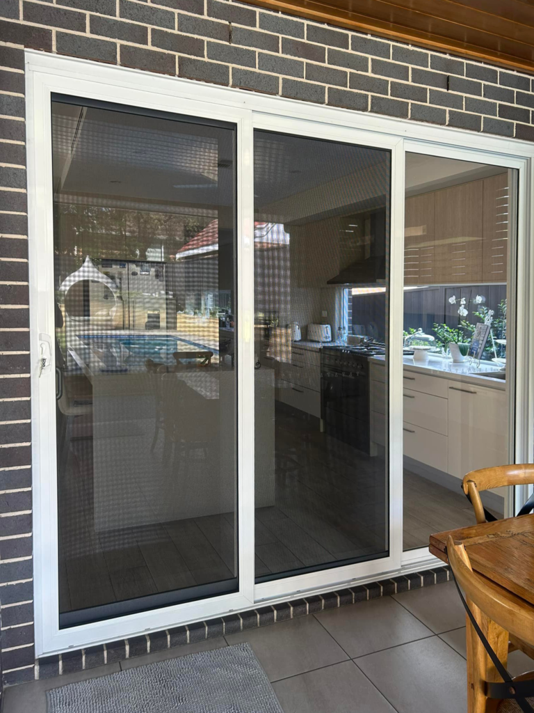 Security sliding doors opening to outdoor area installed by Olsen Security