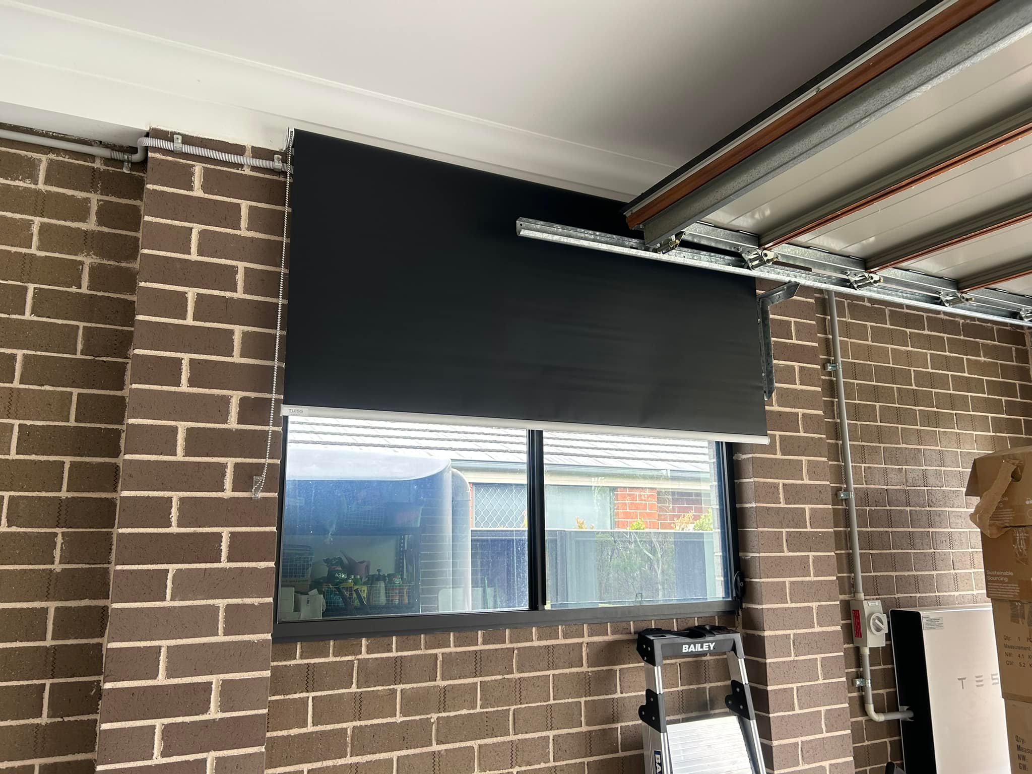 Plantation shutters, blinds, shades & privacy screens Roller blinds on sliding windows in workshop installed by Olsen Security