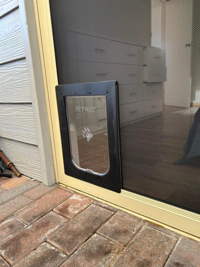 Sliding door with heavy-duty flyscreen door and pet door installed by Olsen Security