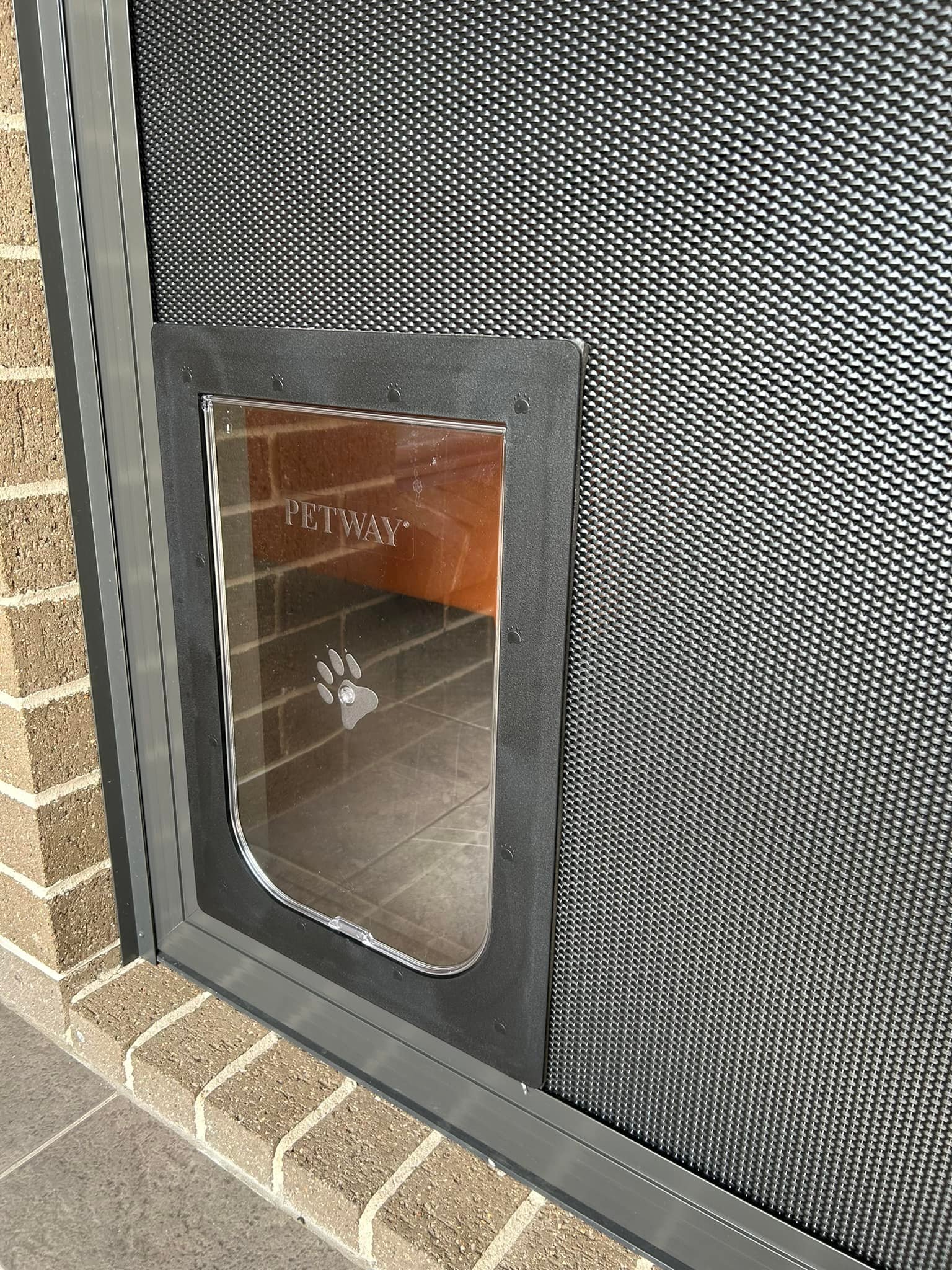 Sliding door with heavy-duty flyscreen door and pet door installed by Olsen Security