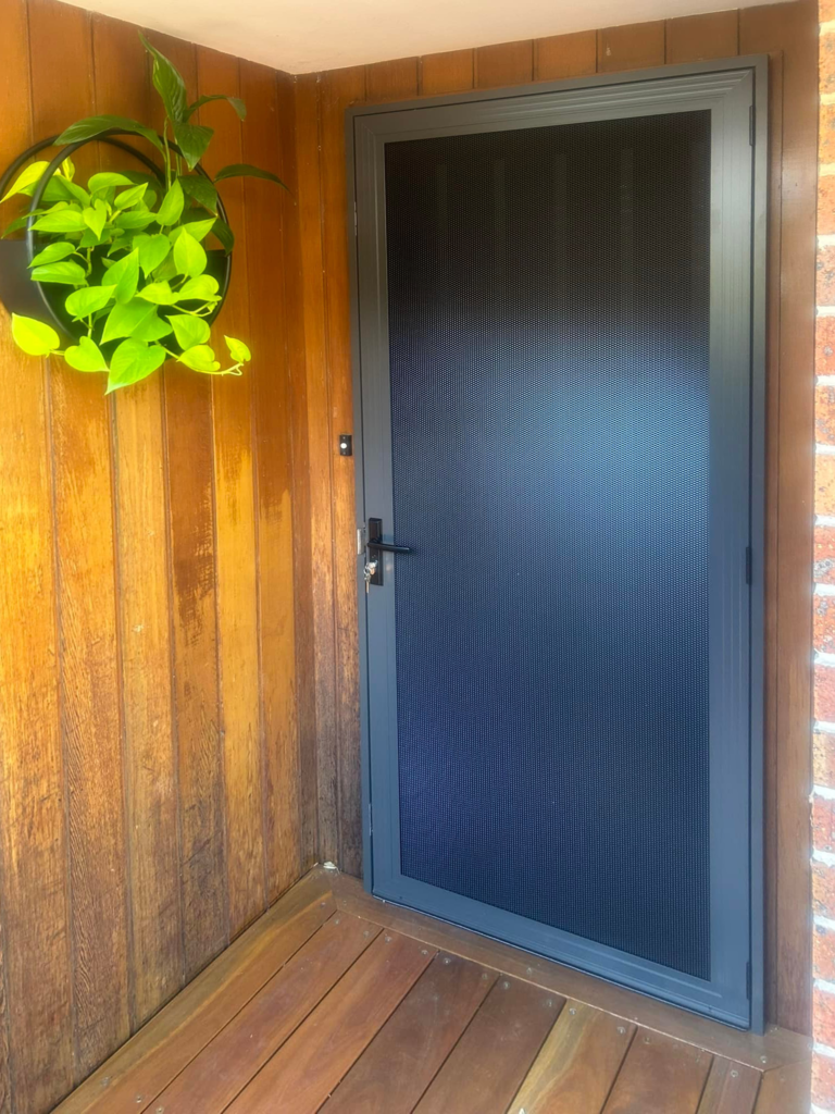 Security screen door on front entrance installed by Olsen Security
