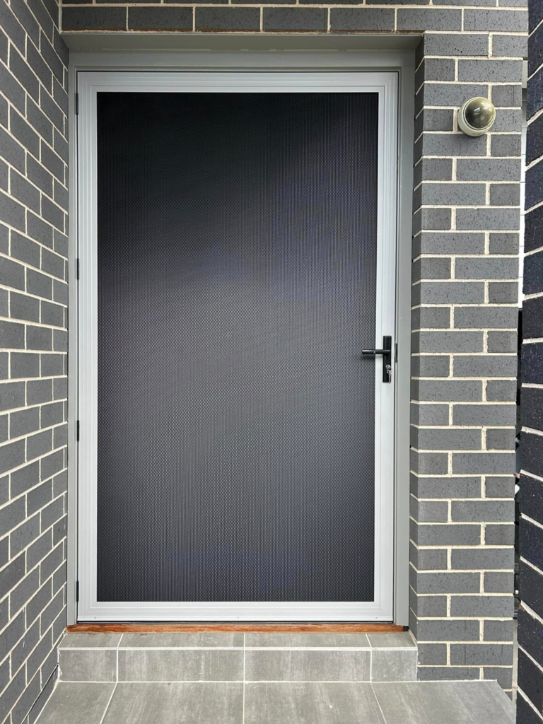 Security screen door on front entrance installed by Olsen Security