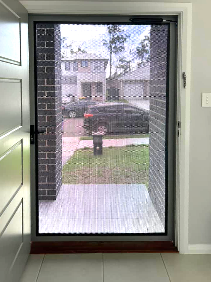 Security screen door on front entrance installed by Olsen Security
