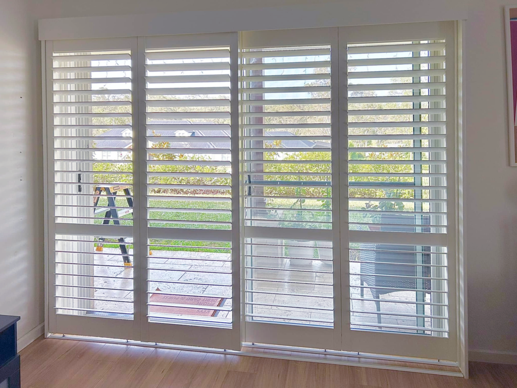 Plantation shutters, blinds, shades & privacy screens Sliding plantation shutters on sliding doors in bedroom installed by Olsen Security