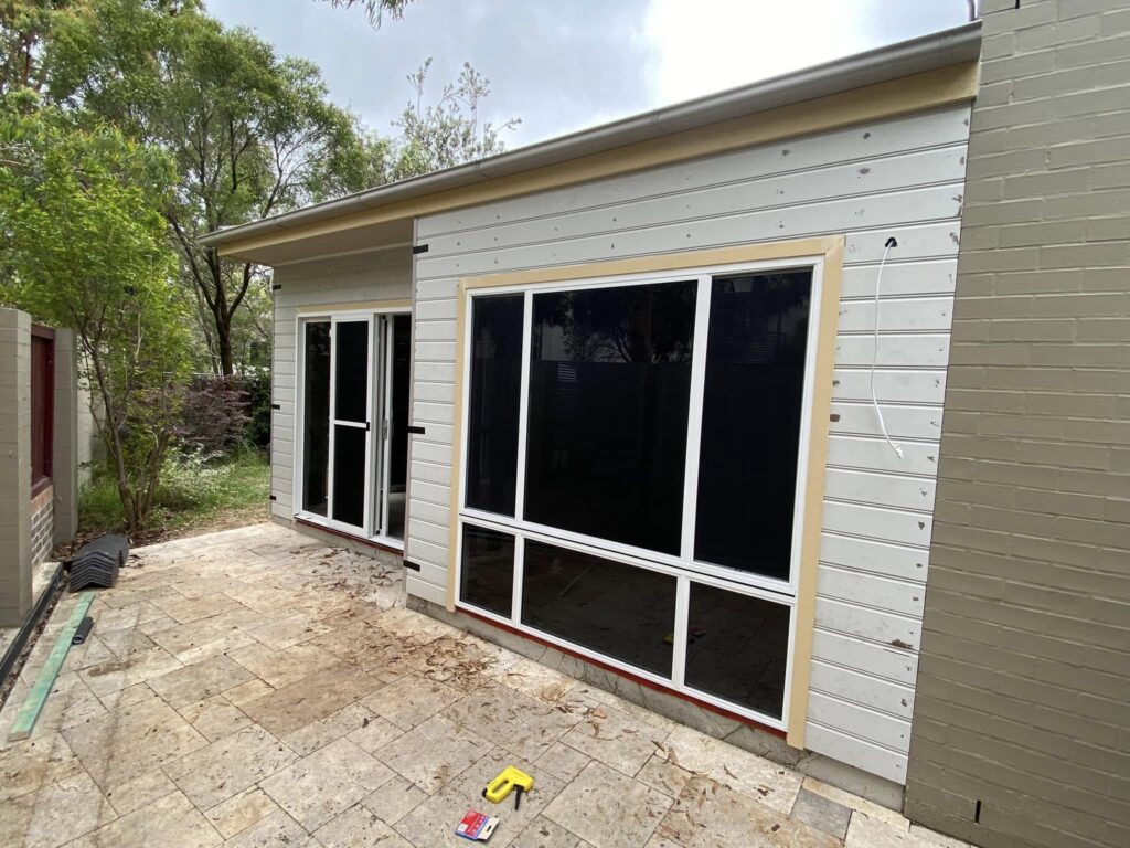 JDS Construction & Design - ScreenGuard security sliding doors on sliding doors opening to outdoor area, and ScreenGuard security mesh on sliding windows installed by Olsen Security