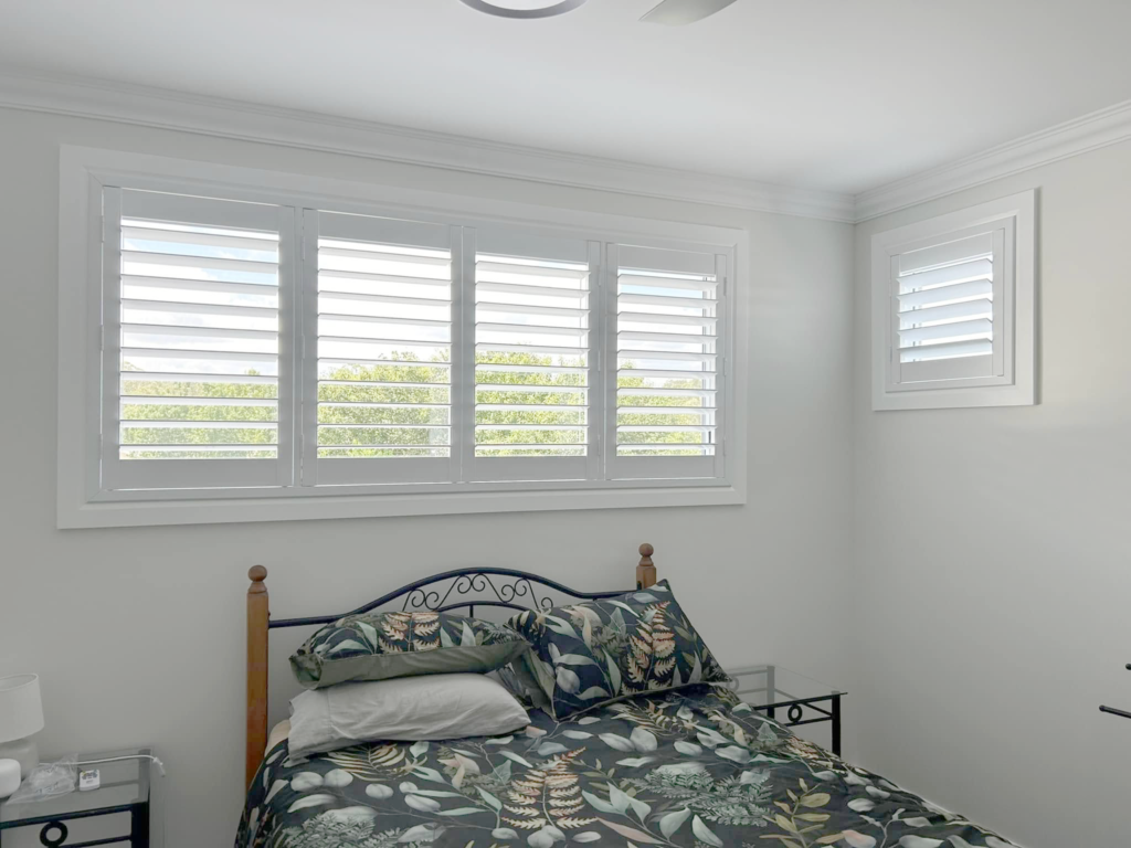 Plantation shutters, blinds, shades & privacy screens Plantation shutters on sliding windows in bedroom installed by Olsen Security