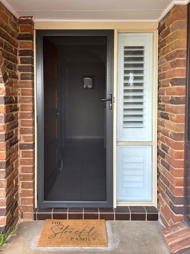 Security screen door on front entrance installed by Olsen Security