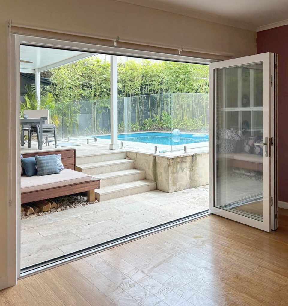 Stacker doors opening to outdoor entertainment area installed by Olsen Security