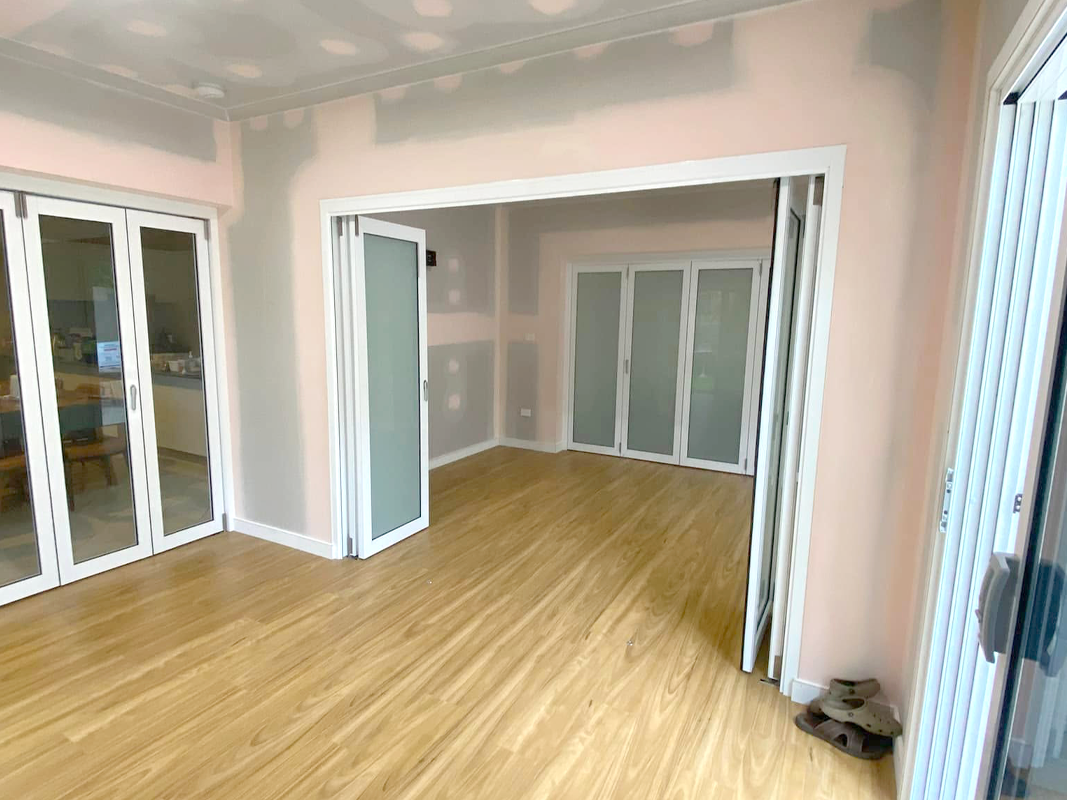 JDS Construction & Design - Stacker doors opening to adjoining living rooms, and ScreenGuard security sliding doors on sliding doors opening to outdoor area installed by Olsen Security