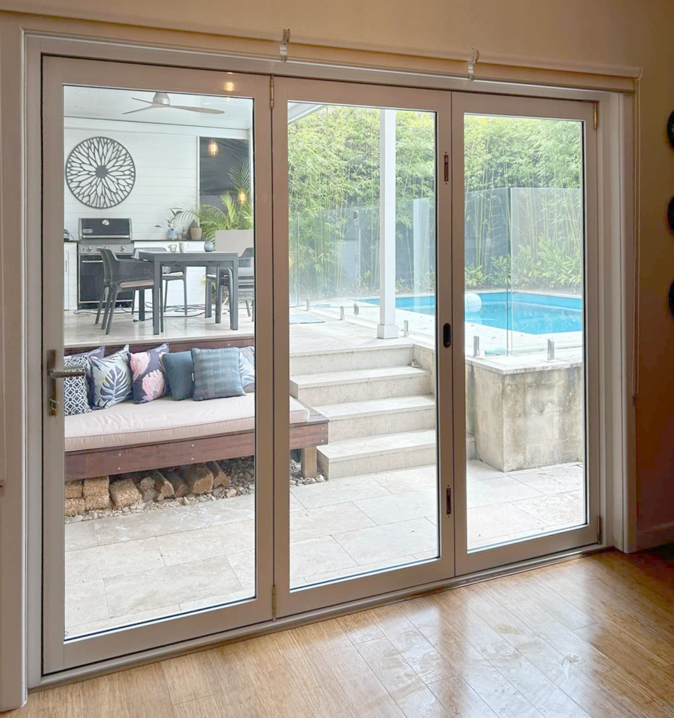 Stacker doors opening to outdoor entertainment area installed by Olsen Security