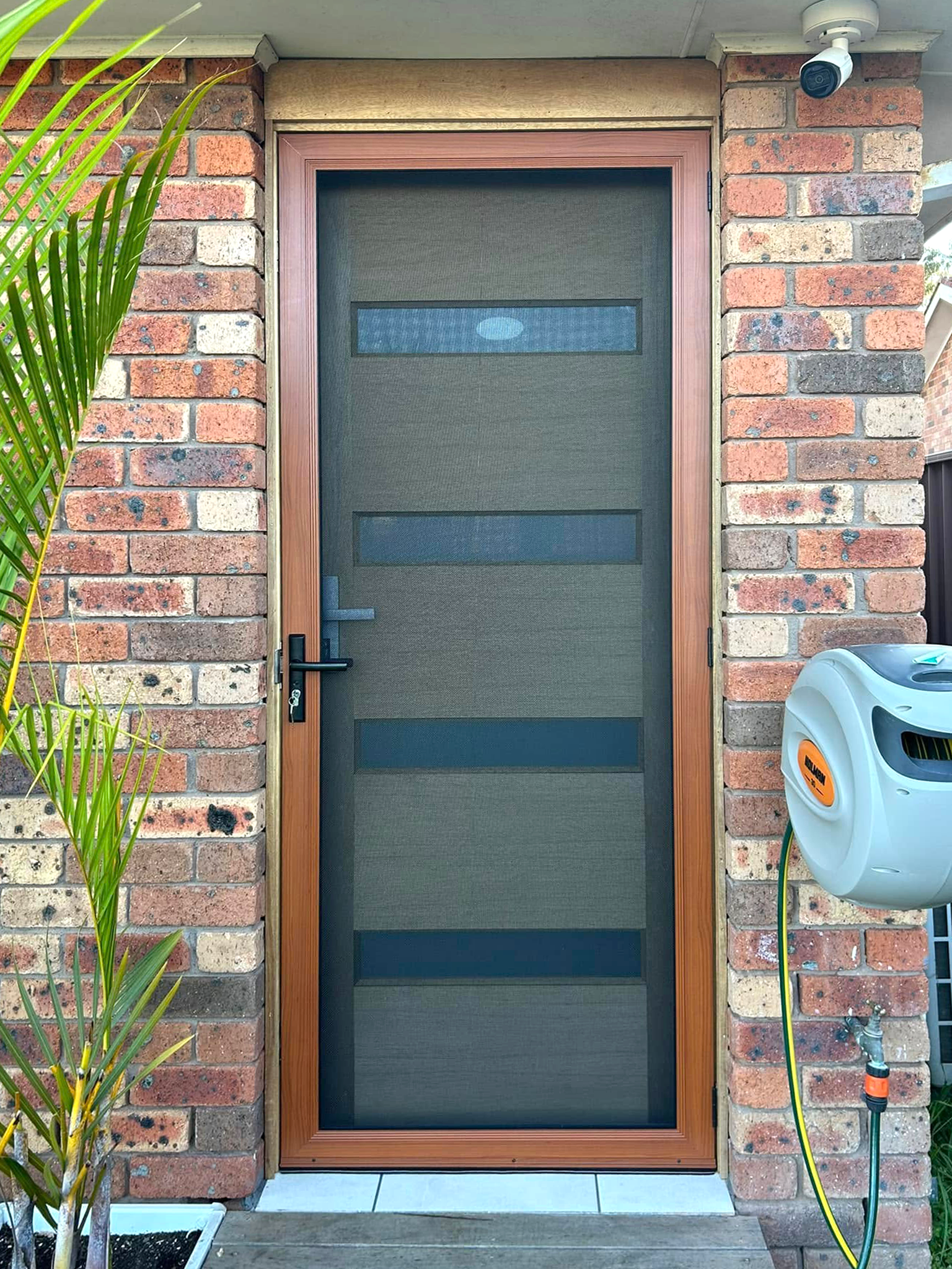 Security screen door on front entrance installed by Olsen Security