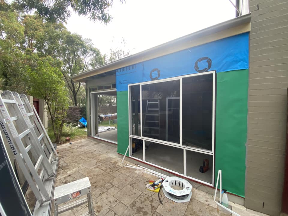 JDS Construction & Design - ScreenGuard security sliding doors on sliding doors opening to outdoor area, and ScreenGuard security mesh on awning windows installed by Olsen Security