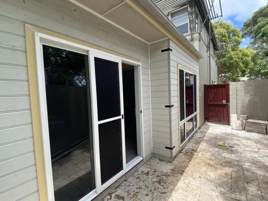 JDS Construction & Design - ScreenGuard security sliding doors on sliding doors opening to outdoor area, and ScreenGuard security mesh on sliding windows installed by Olsen Security