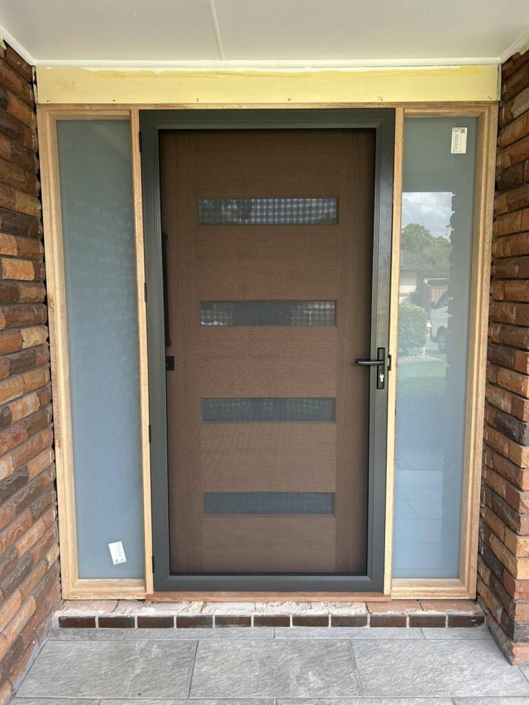 Hinged wooden entrance door with ScreenGuard security mesh door and sidelights installed by Olsen Security