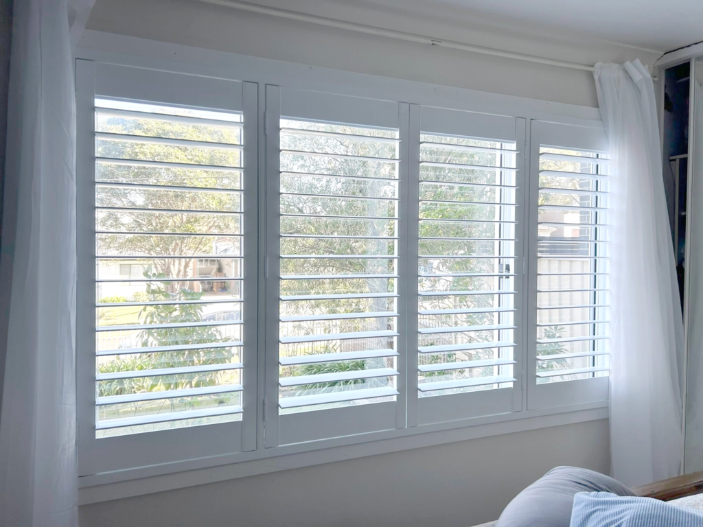 Plantation shutters, blinds, shades & privacy screens Plantation shutters on sliding windows in bedroom installed by Olsen Security