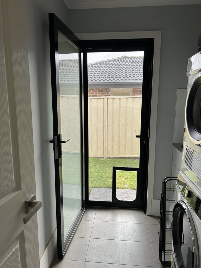 Side door with heavy-duty flyscreen door and pet door installed by Olsen Security