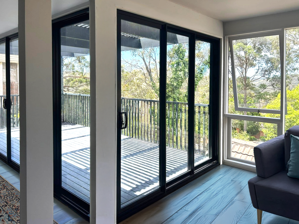 Corner stacking doors for living room opening out to deck installed by Olsen Security for Renovate Instyle project.