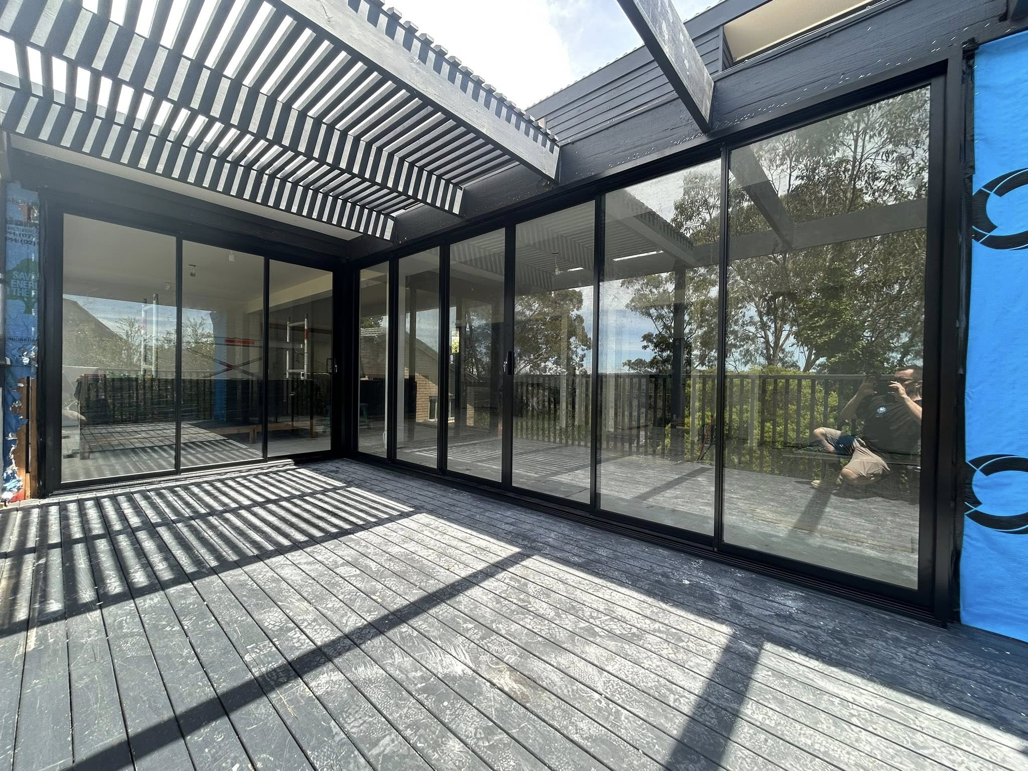 Corner stacking doors for living room opening out to deck installed by Olsen Security for Renovate Instyle project.