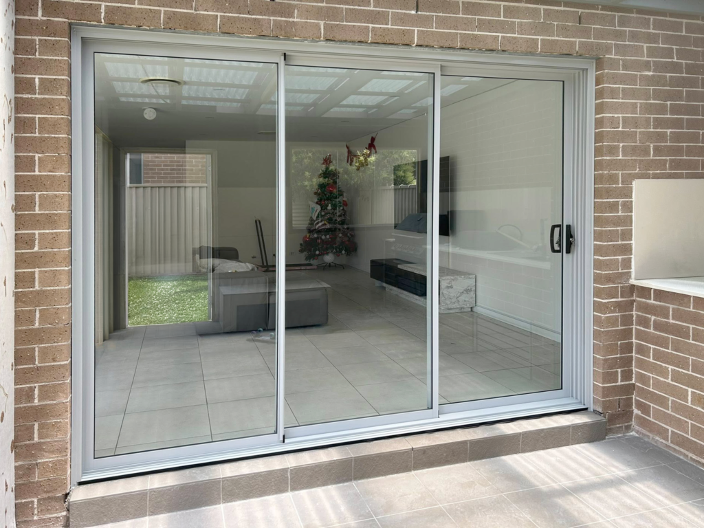 Our Projects Sliding doors opening out to outdoor entertainment area installed by Olsen Security