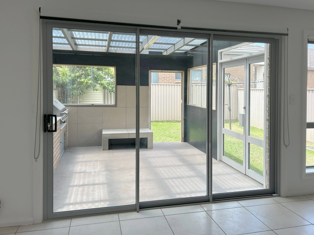 Our Projects Sliding doors opening out to outdoor entertainment area installed by Olsen Security
