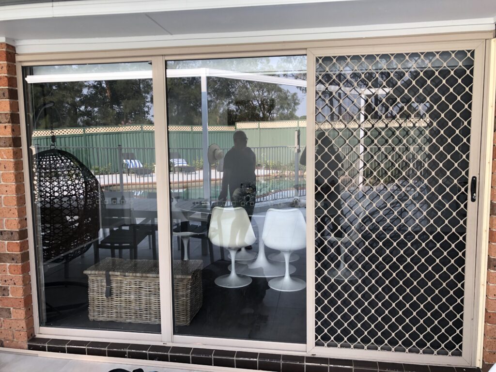 Security grill and mesh sliding doors on sliding doors to patio installed by Olsen Security