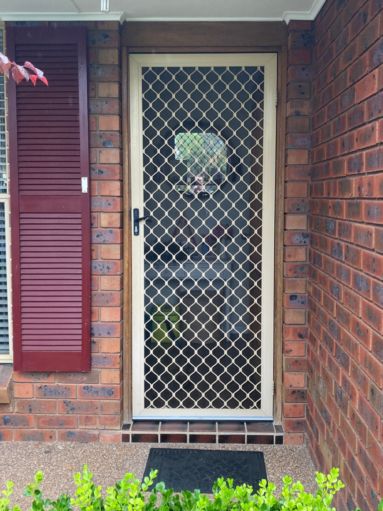 Security grill and mesh door on front entrance installed by Olsen Security