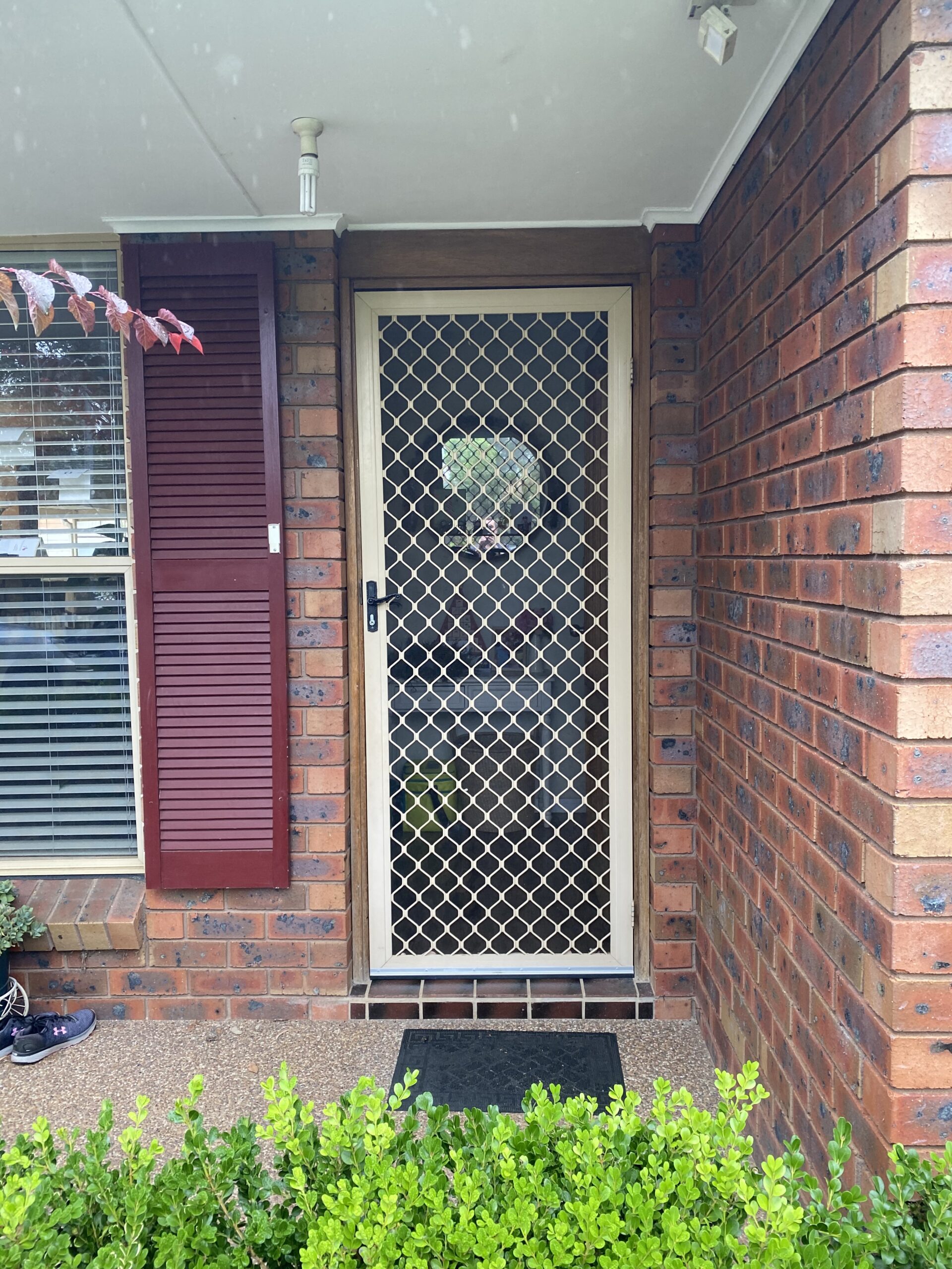 Security grill and mesh door on front entrance installed by Olsen Security