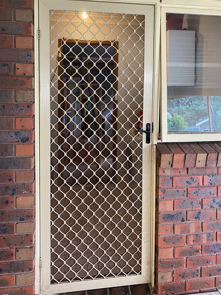 Security grill door on front entrance installed by Olsen Security