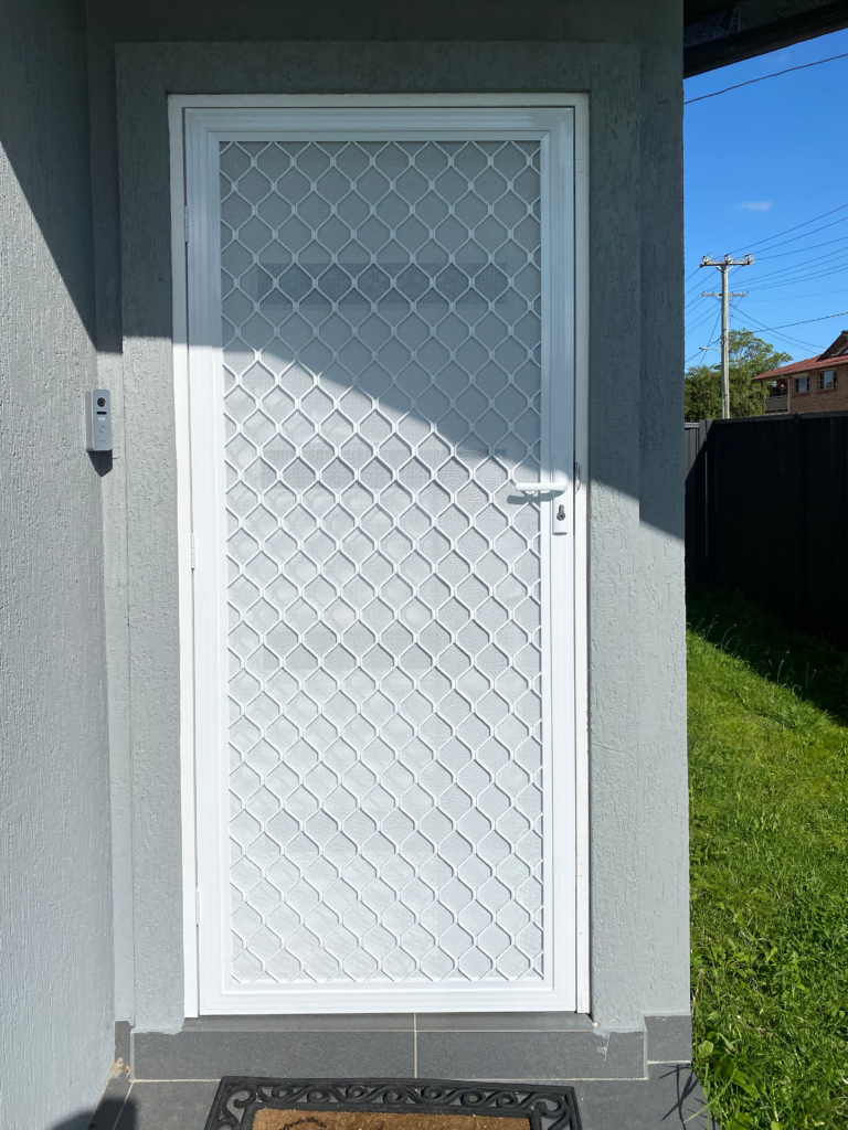 Security grill and mesh door on front entrance installed by Olsen Security