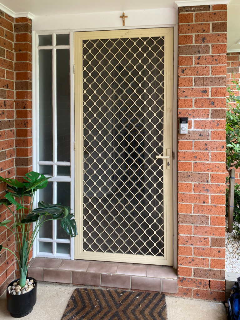 Security grill and mesh door on front entrance installed by Olsen Security