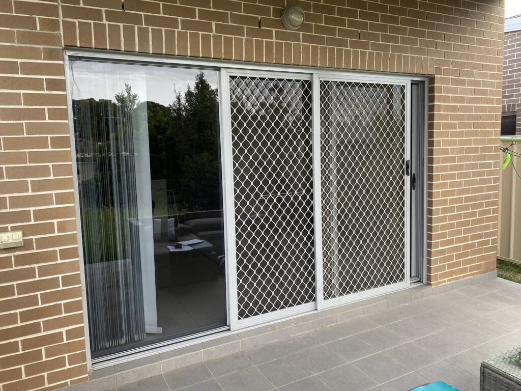 Security grill and mesh sliding doors on sliding doors to patio installed by Olsen Security