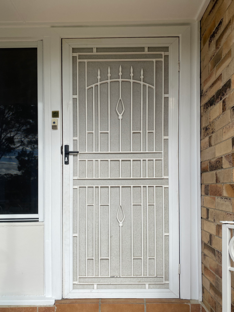 Security grill and mesh door on front entrance installed by Olsen Security