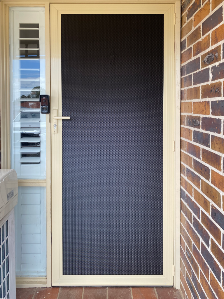Heavy-duty security mesh door on front entrance installed by Olsen Security