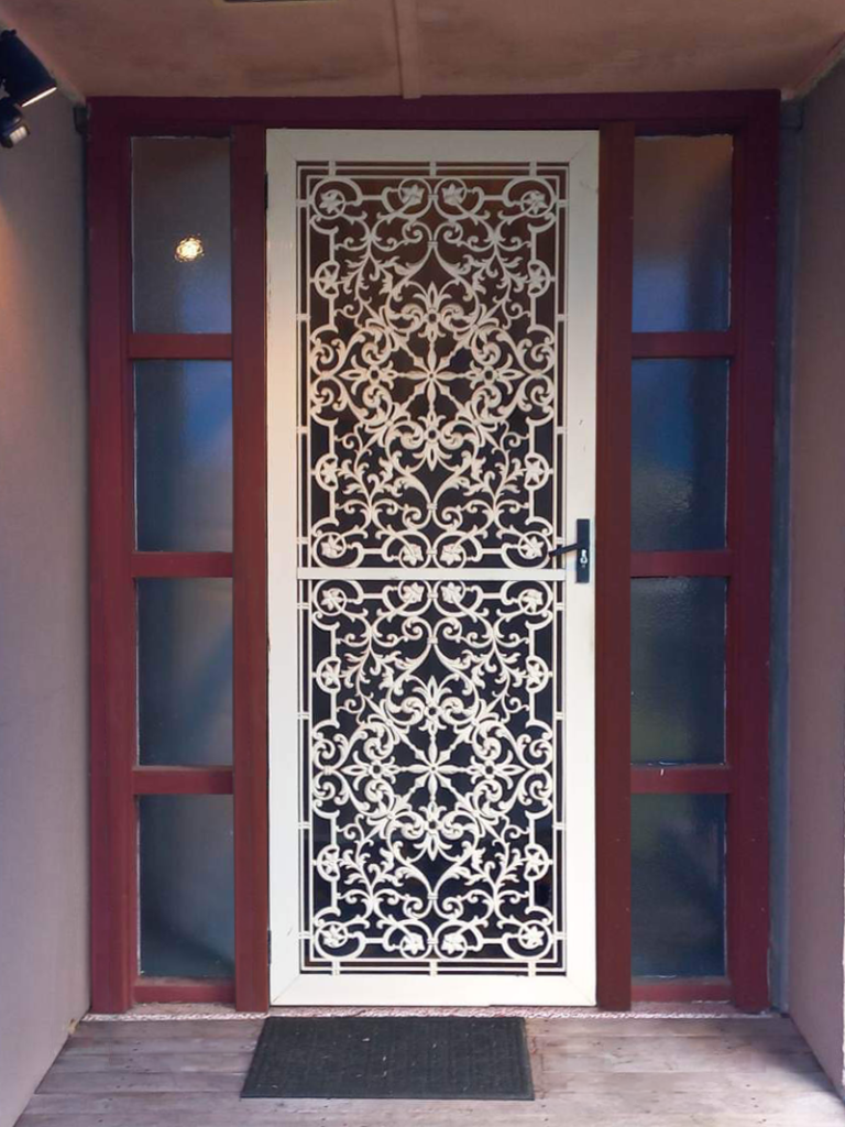 Security grill door with mesh on front entrance with sidelights installed by Olsen Security