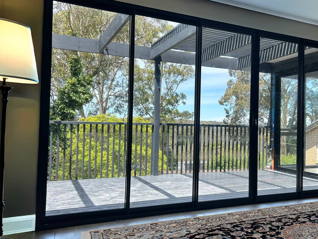 Corner stacking doors for living room opening out to deck installed by Olsen Security for Renovate Instyle project.