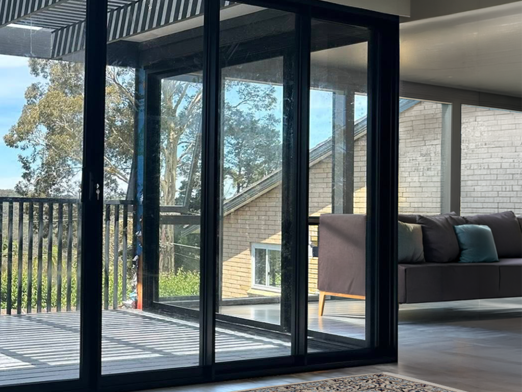Corner stacking doors for living room opening out to deck installed by Olsen Security for Renovate Instyle project.