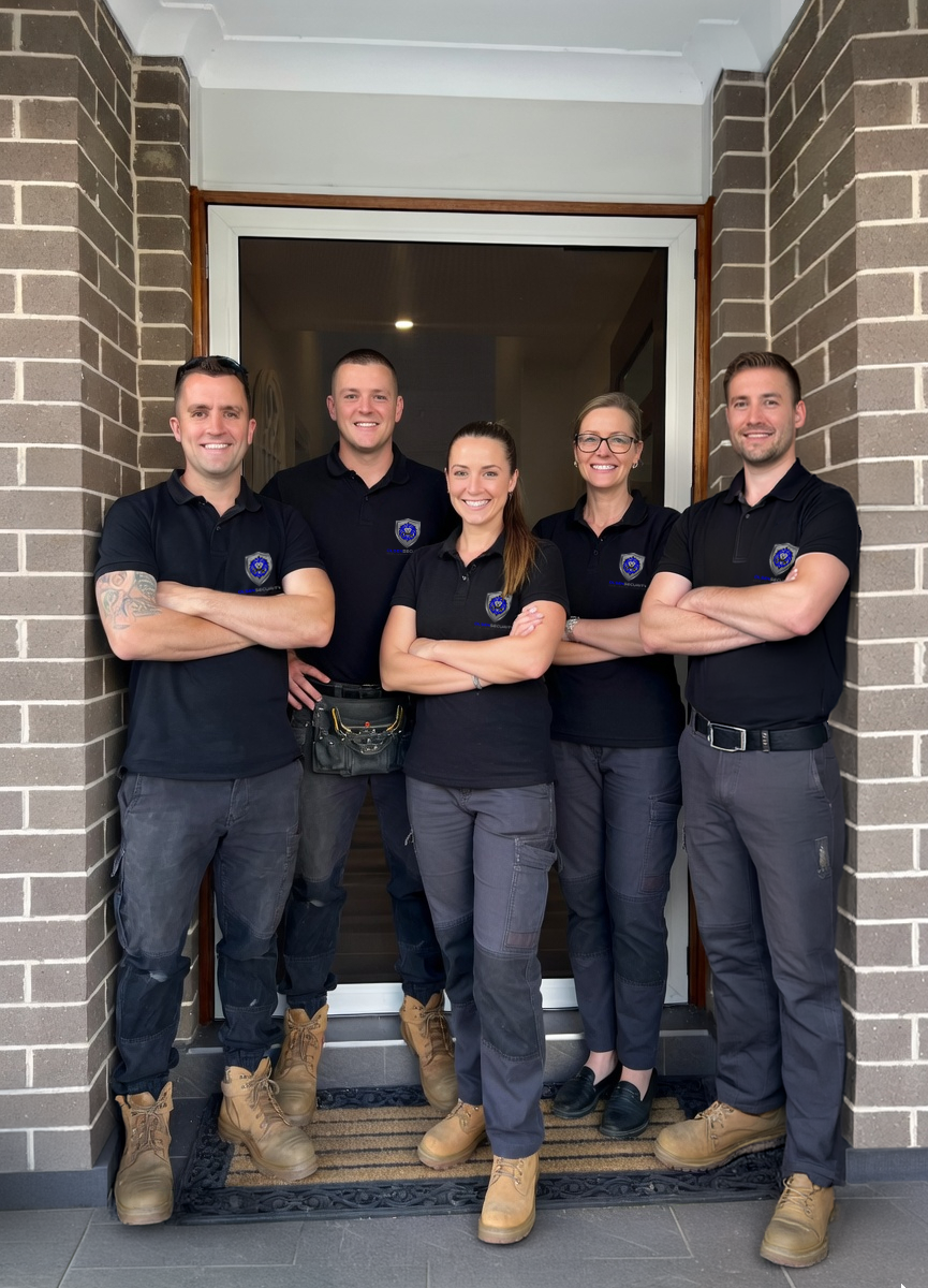 Nathan Olsen and Olsen Security Team standing in front of ScreenGuard security hinged front door.