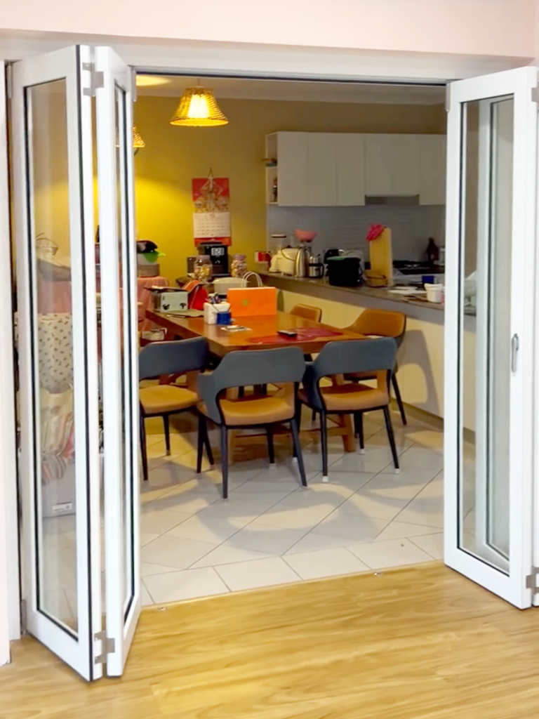 JDS Construction & Design - Stacker doors opening to adjoining living room installed by Olsen Security