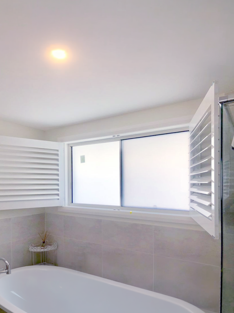 Plantation shutters, blinds, shades & privacy screens Plantation shutters on sliding windows in bathroom installed by Olsen Security